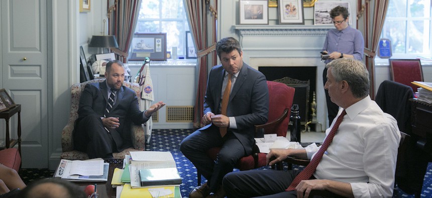 New York City Council Speaker Corey Johnson and Mayor Bill de Blasio discuss the budget shortly before the handshake agreement.