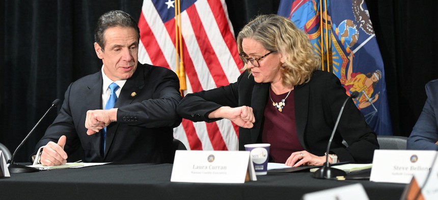 Governor Cuomo and Nassau County Executive Laura Curran bump elbows instead of shaking hans at the coronavirus briefing on March 5th.