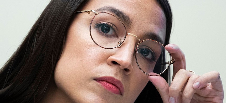 Rep. Alexandria Ocasio-Cortez listens as Chairman and CEO of Facebook Mark Zuckerberg answers her questions, during his testimony at the US House Financial Services Committee hearing. 