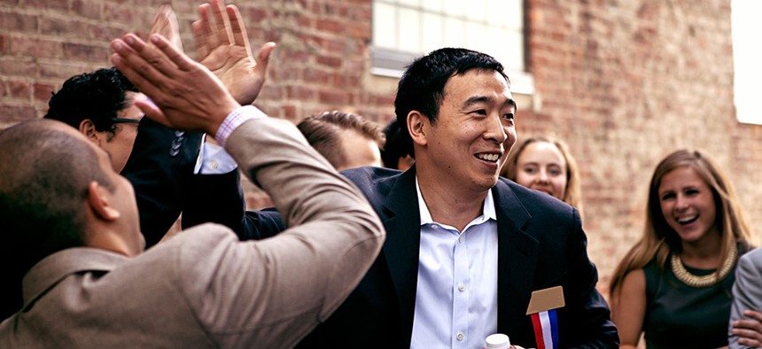 Presidential hopeful Andrew Yang surrounded by supporters.