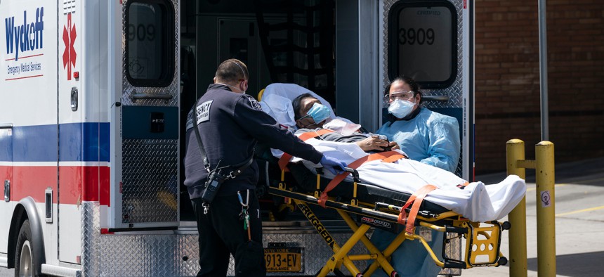 Emergency medical technicians bring patient to Wyckoff Heights Medical Center for treatment amid COVID-19 pandemic in April.