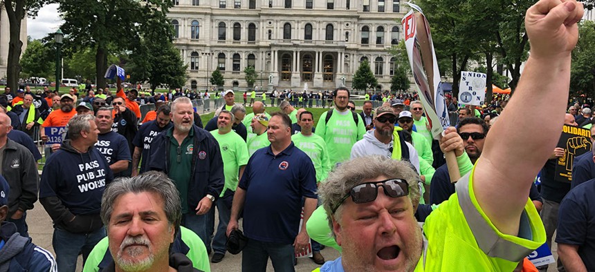 Union members rally outside of New York's capitol building in Albany on June 11.