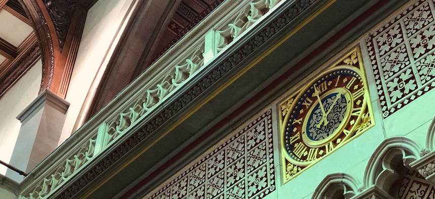 An ornate clock hanging in Albany's State Capitol building.