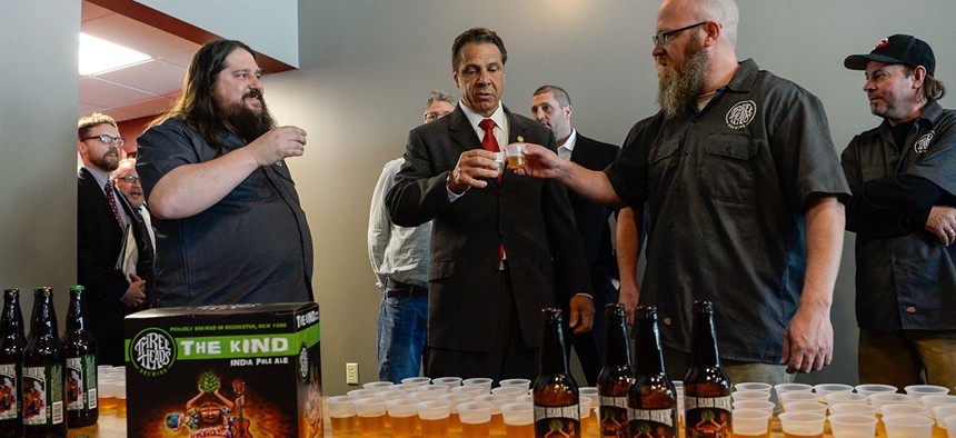 Governor Cuomo cutting the ribbon at Three Heads Brewing in Rochester in 2016.