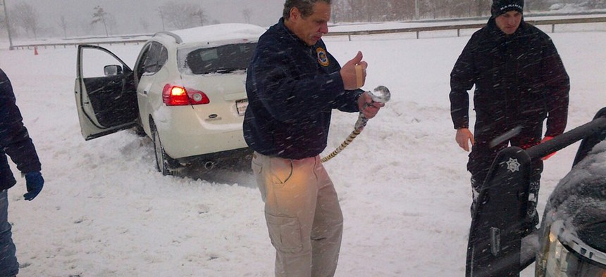 Cuomo assisting a stranded driver on Cross Island Parkway.