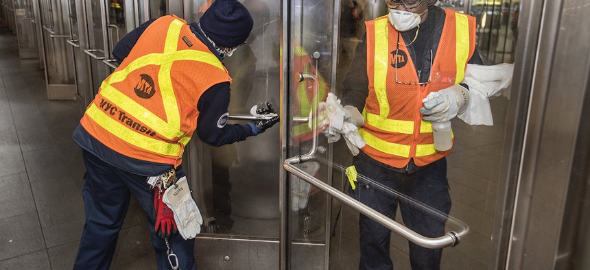 MTA works disinfecting frequently used surfaces at Fulton Center.