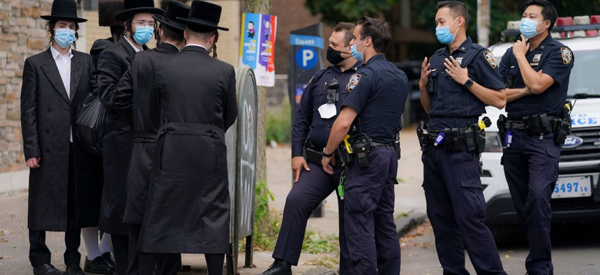 NYPD officers talk to members of the Orthodox community in Borough Park on October 7th.