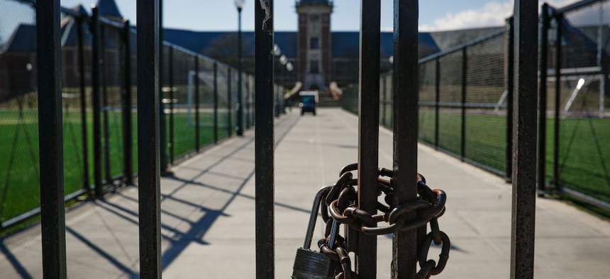 Padlock and chain on a gate leading to New Rochelle High School  in May 2020.