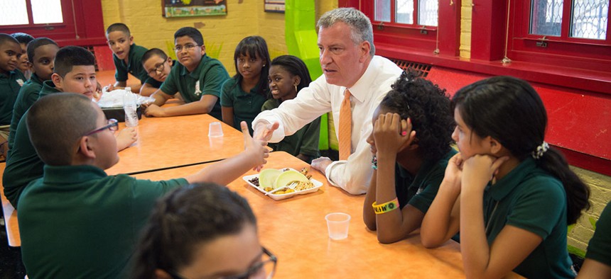 Mayor Bill de Blasio enjoys lunch with students at school.