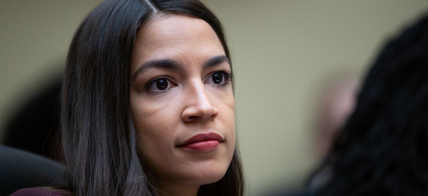Rep. Alexandria Ocasio-Cortez listens to witnesses in a House Oversight Committee hearing.