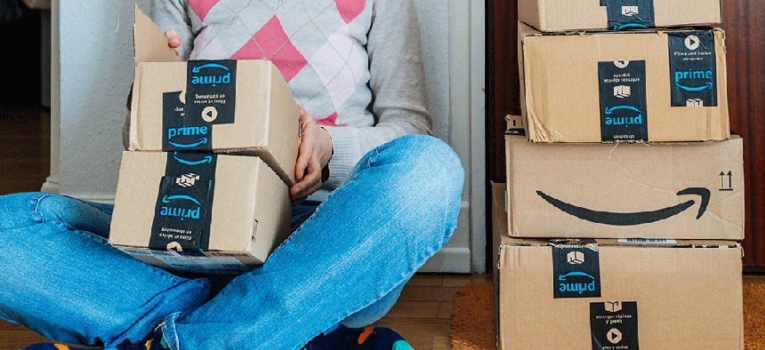 A woman surrounded by Amazon packages.