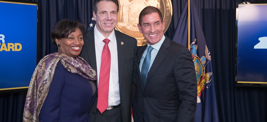 State Senate Majority Leader Andrea Stewart-Cousins smiles alongside Gov. Andrew Cuomo and state Sen. Jeff Klein after Cuomo brokered the deal to dismantle the Independent Democratic Conference last year