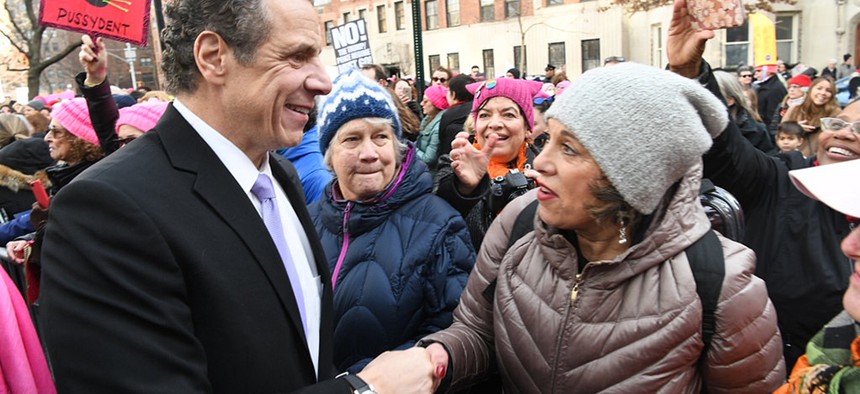 Andrew Cuomo shakes a woman's hand at the Women's March in New York City