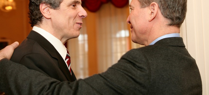 Andrew Cuomo and Eric Schneiderman shake hands at a reception for the the New York State Association of Black and Puerto Rican Legislators, Inc. 40th Annual Legislative Conference in 2011. 