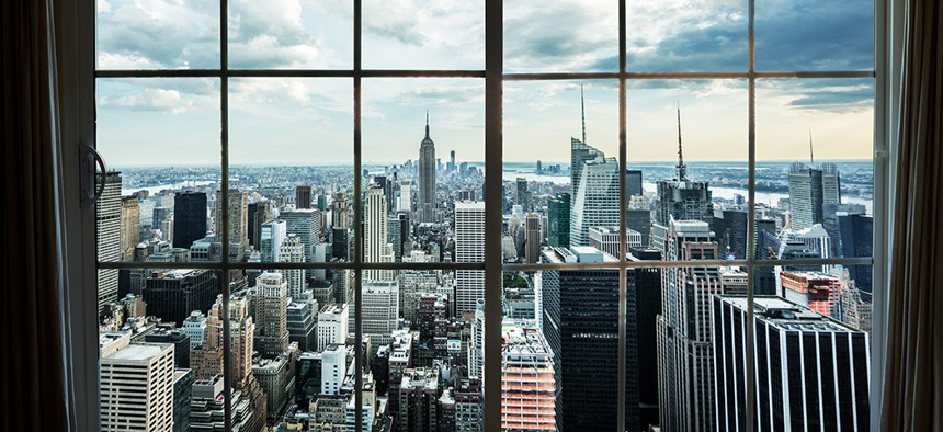 The Manhattan skyline looking out of a high rise window.