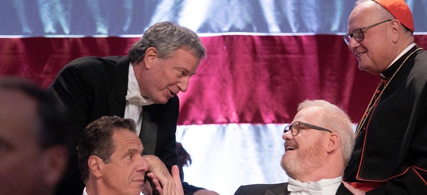 New York City Mayor Bill de Blasio shakes hands with comedian Jim Gaffigan at the 73rd Annual Alfred E. Smith Memorial Foundation Dinner in midtown Manhattan.