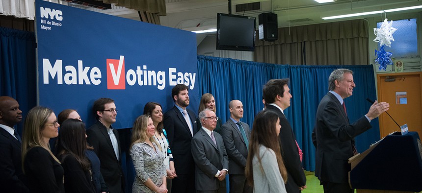 Mayor Bill de Blasio signs legislation to create a online voter registration system in December, 2017.