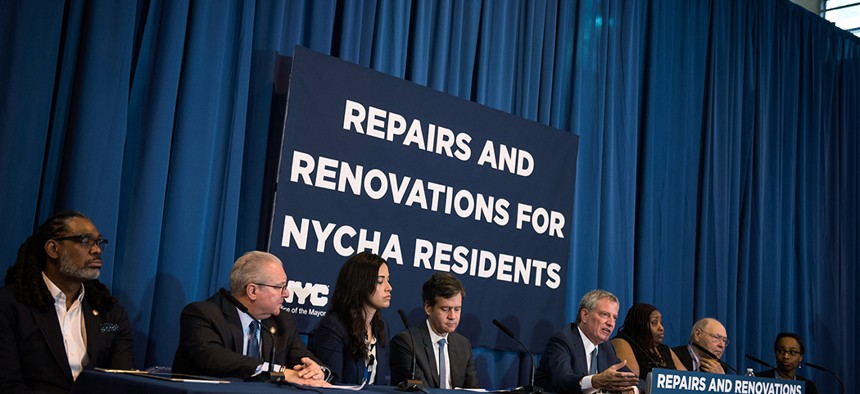 New York City Mayor Bill de Blasio announces a commitment from the New York City Housing Authority to renovate nearly 2,400 apartments on June 25. 