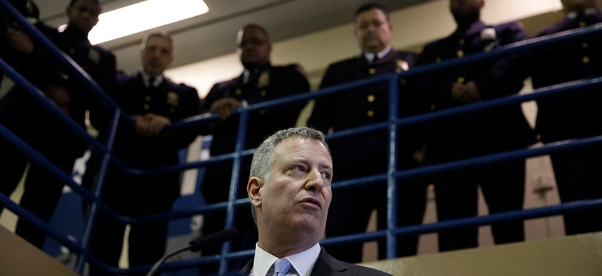 New York City Mayor Bill de Blasio surrounded by corrections officers during a news conference on Rikers Island in 2015