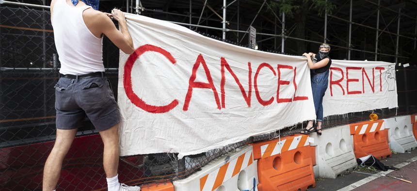 Activists hang a cancel rent sign in New York City on August 6, 2020.