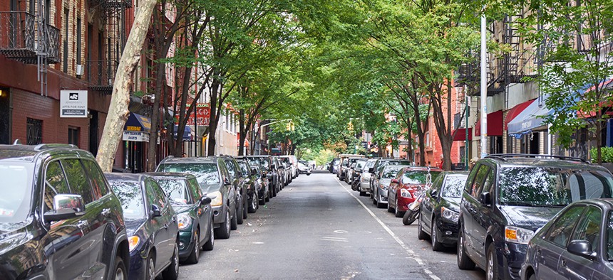 Cars parked along both sides of a Manhattan street.