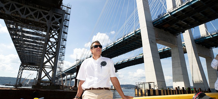 Andrew Cuomo standing in front of the Mario Cuomo Bridge