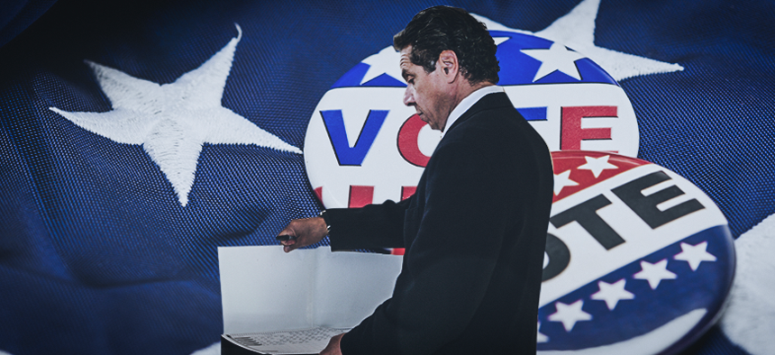 Andrew Cuomo voting with a flag behind him