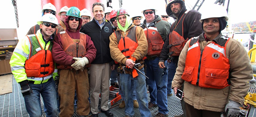 Andrew Cuomo stands with construction workers