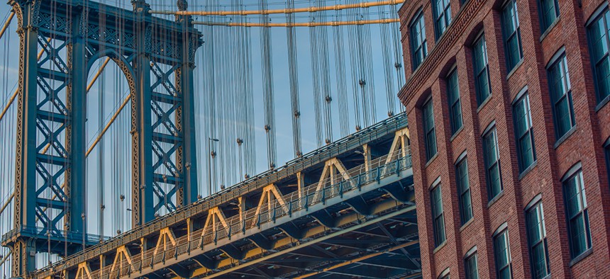 View of one of the towers of the Manhattan Bridge from the streets of the DUMBO district, Brooklyn, NYC