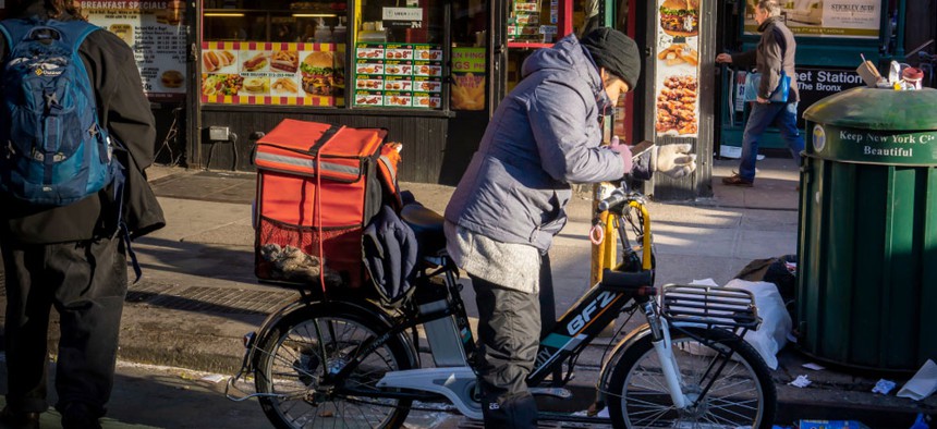 A deliveryman on his Dongguan BuFengZhe (BFZ) electric bike making deliveries in New York in the Chelsea neighborhood. 