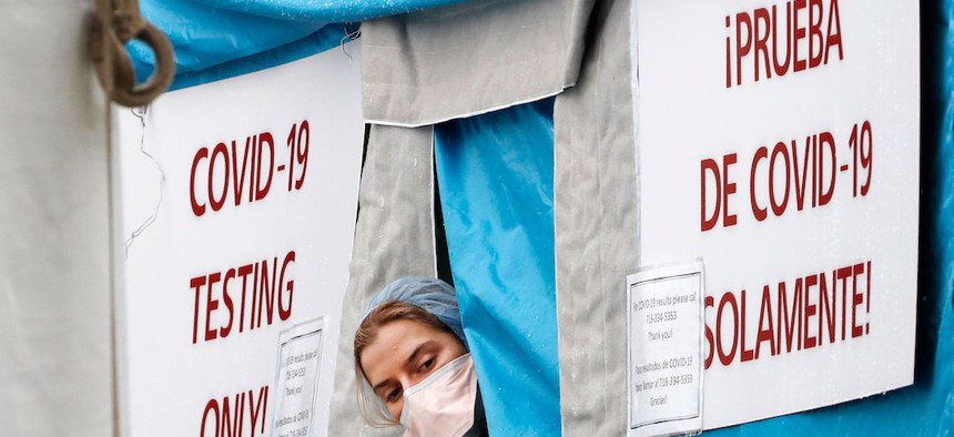 A medical worker sticking her head outside of a COVID-19 testing tent at Elmhurst Hospital Center in New York.