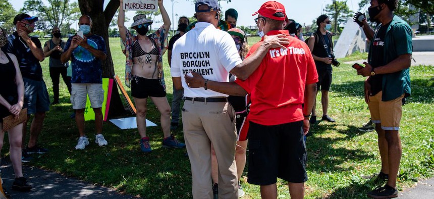 Brooklyn Borough President Eric Adams (left) speaks with Black Lives Matter protestors on July 18, 2020. 