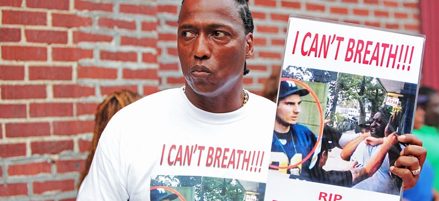 A man attending funeral services for Eric Garner, the Staten Island resident who died while being taken into custody by an NYPD officer in 2014.