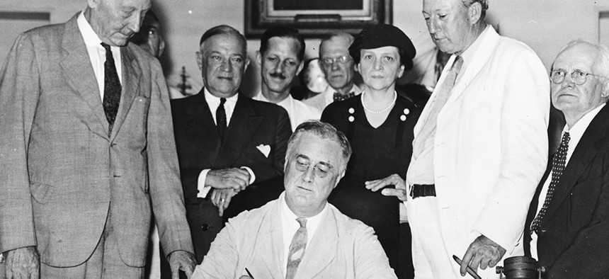 President Franklin Delano Roosevelt signs the Social Security Act on August 13, 1935. 