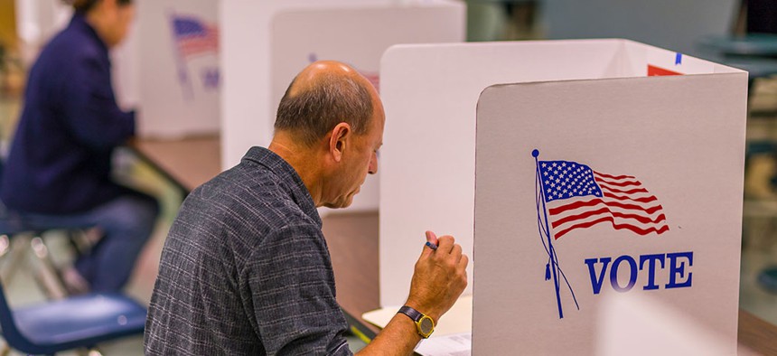 A civilian casts a vote.