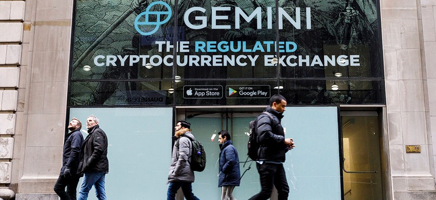 New Yorkers walk past an advertisement for Gemini, a cryptocurrency exchange founded in 2014.