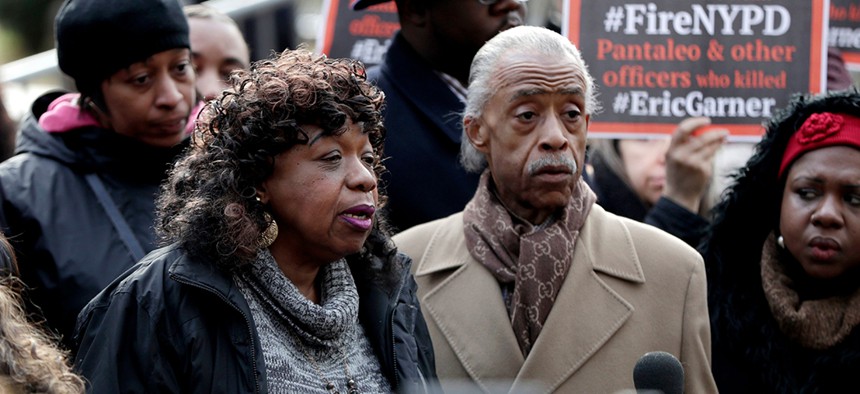 Gwen Carr, mother of Eric Garner, stands with Rev. Al Sharpton during a news conference outside of New York Police headquarters.