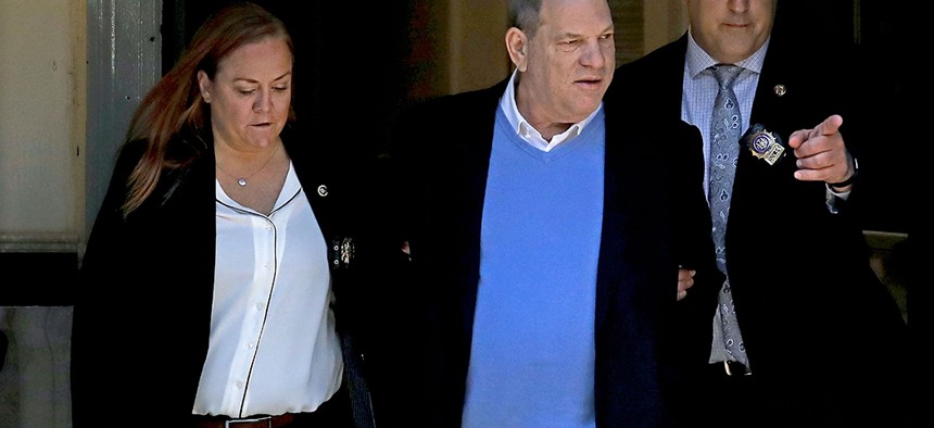 Harvey Weinstein being led away in handcuffs from the First Police Precinct in Manhattan. 