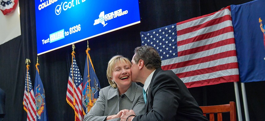 Hillary Clinton and Gov. Andrew Cuomo sign legislation for enacting the Excelsior Scholarship Program. 