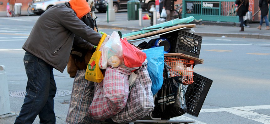 Homeless person pushing a shopping cart in New York City