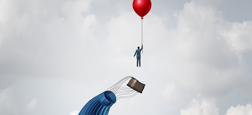 A man departs a hot air balloon via helium balloon.