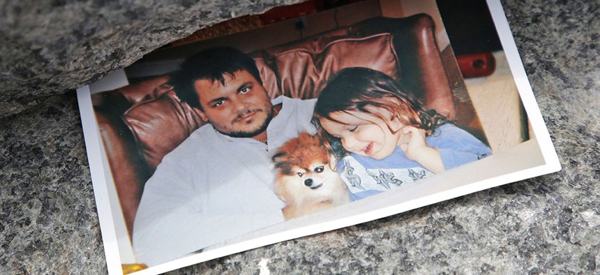 A photo of James Zadroga and his daughter on display at a Ground Zero memorial in New York.