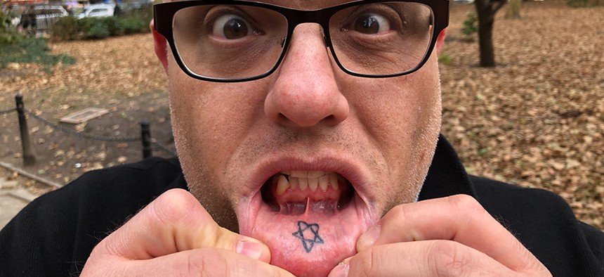 Justin Bannan exposing his lip tattoo