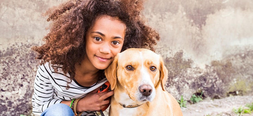 A young girl with her dog.