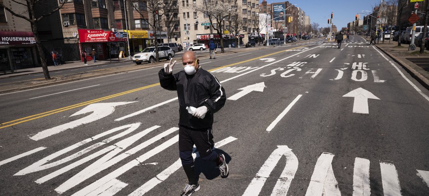 A man jogs along a section of the Grand Concourse in the Bronx that has been temporarily closed in an effort to provide more social distancing space.