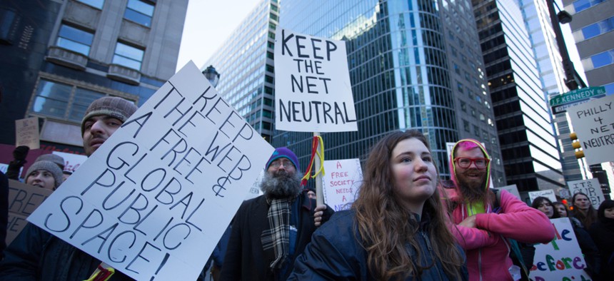 Net neutrality supporters protest outside of Comcast's headquarters in 2018.