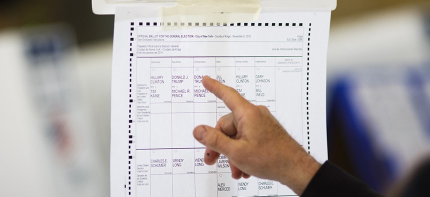 A voter looks over a sample 2016 New York ballot showing presidential candidates on multiple party lines. 