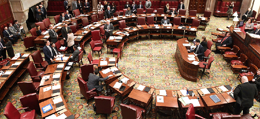Members of the New York state Senate working on the state budget in the Senate Chamber.