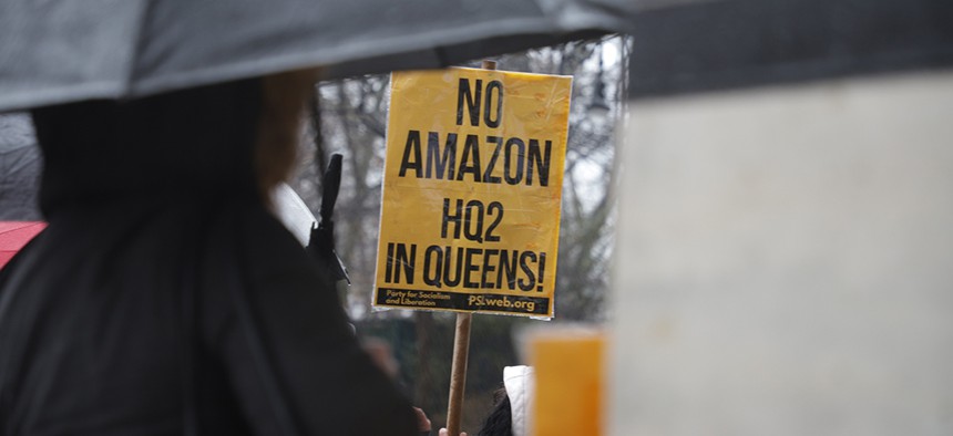 A protester holds a No Amazon HQ2 in Queens sign