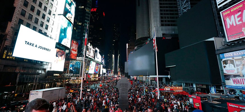 Screens in Times Square went black during a power outage in New York City on Saturday.